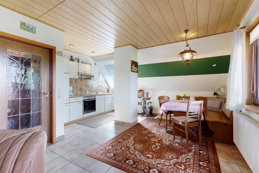 a kitchen with a table and a dining room at Ferienwohnung Haus Barbara in Bräunlingen