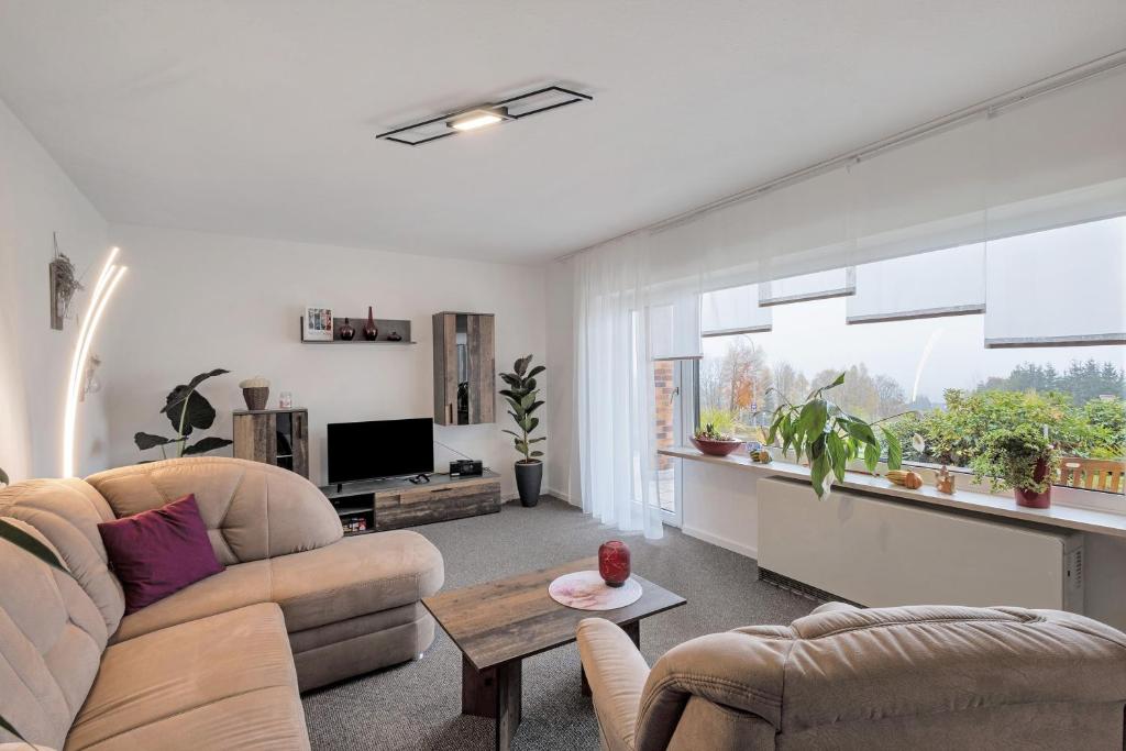 a living room with a couch and a table at Naturoase Fichtelberg in Fichtelberg