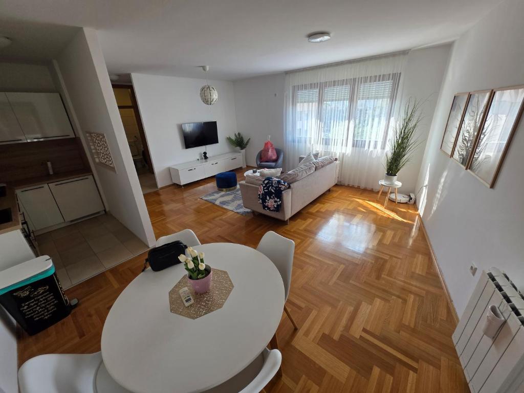 a living room with a white table and a couch at Area 51 in Banja Luka
