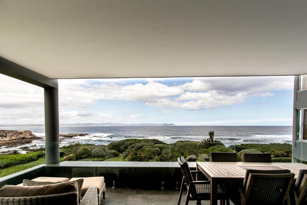 a dining room with a view of the ocean at Bayview 203 in Hermanus