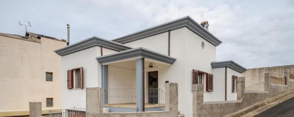 a white house with blue accents at Casa Spaziosa in Bari Sardo