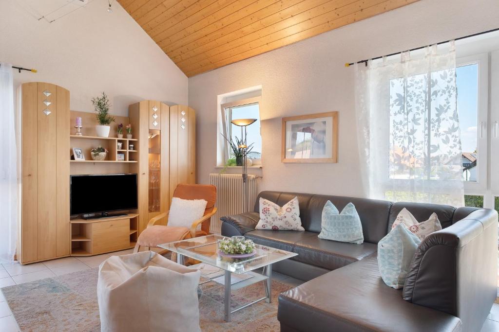 a living room with a couch and a table at Ferienwohnung Lang, 45qm in Sasbach am Kaiserstuhl