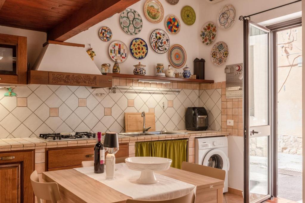 a kitchen with a table and plates on the wall at Cantina Rustica in Montallegro