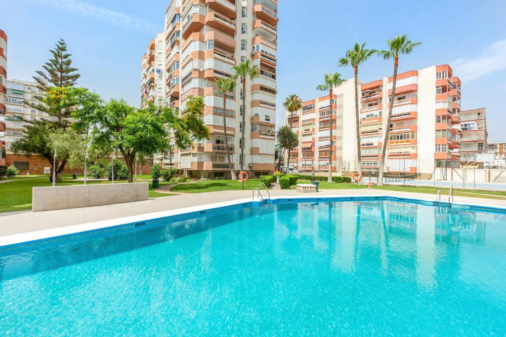 a swimming pool in front of some apartment buildings at Plazamar 044 in Torre del Mar