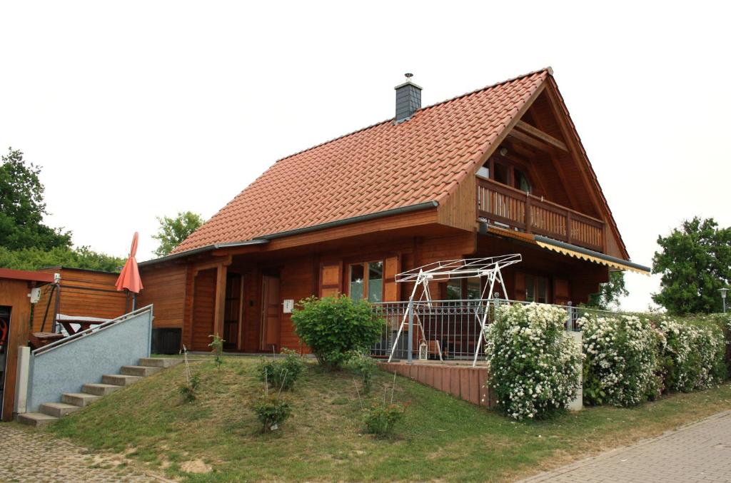 a large wooden house with a porch and stairs at Ferienhaus Zuehlke in Groß Nemerow
