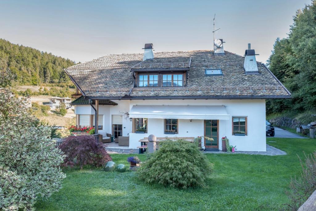 a large white house with a roof at Lotschenhof Apt Tulpe in Trodena