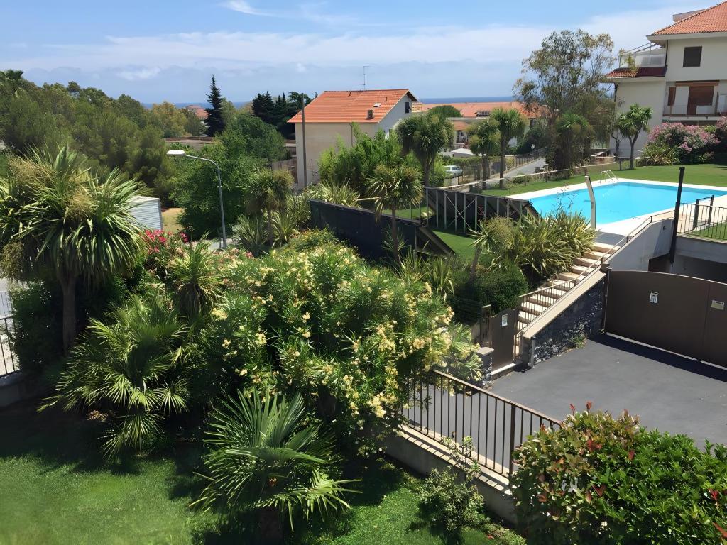 an aerial view of a resort with a swimming pool and trees at Villa di Diana in Diano Castello