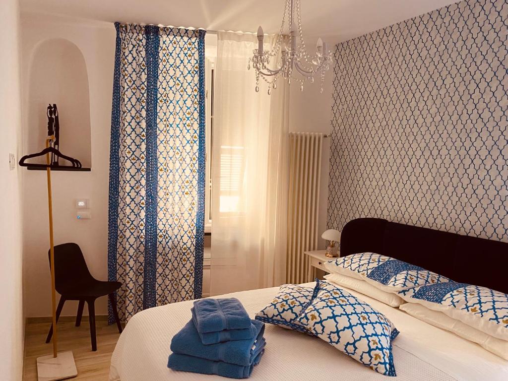 a bedroom with a bed with blue and white curtains at A Vernazza La Conchiglia Doro in Vernazza