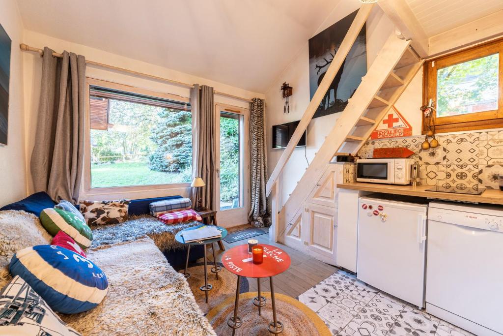 a tiny house with a kitchen and a living room at Appartement Les Cezares in Les Allues