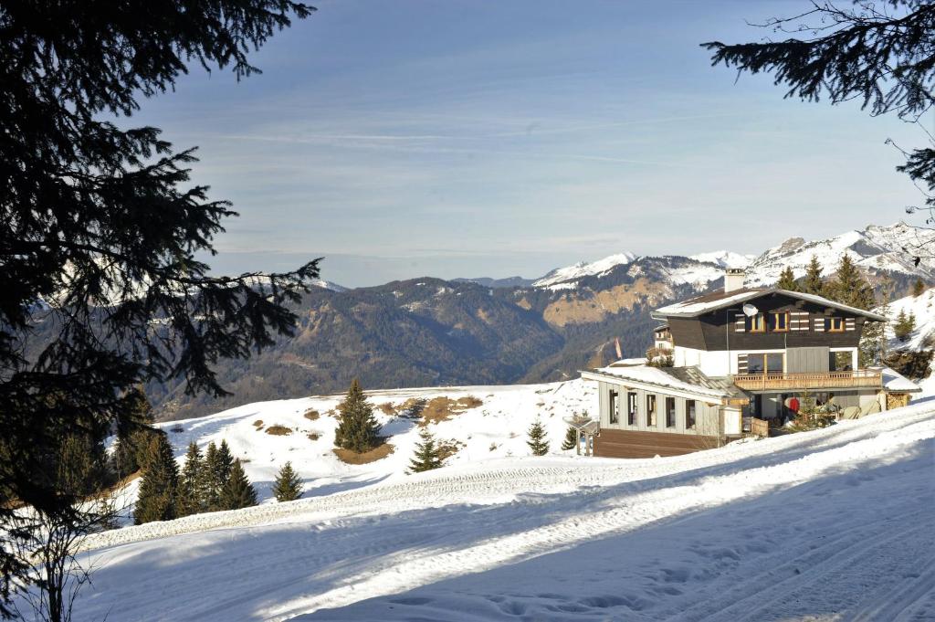 a house on top of a snow covered mountain at Chalet d' Egloo 10-12 pers in Samoëns