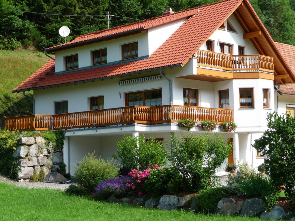 a large white house with a balcony at Haus Sum in Oberwolfach