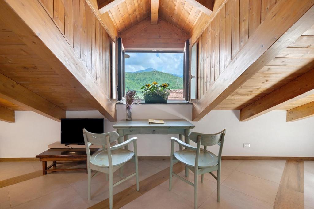 a room with a table and chairs and a window at Appartamenti in Agriturismo in Fisciano