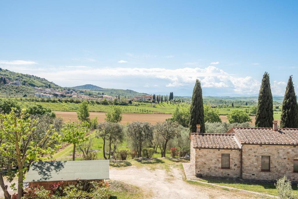 an estate with a view of a field and trees at Podere del Pereto Bio- 201 in Rapolano Terme