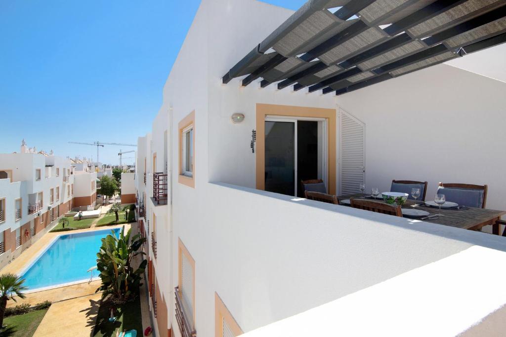a view from the balcony of a house with a swimming pool at Quinta Gomeira 146 in Cabanas de Tavira