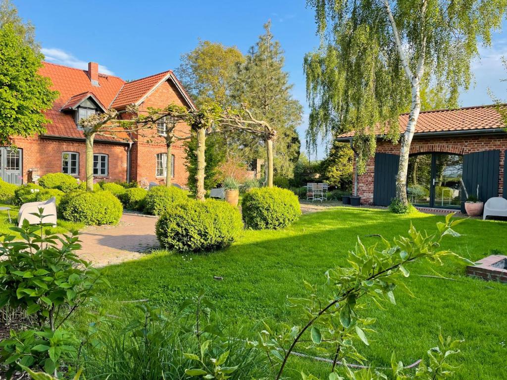 a house with a green yard with a pathway at Ferienwohnung Zwei in Saal