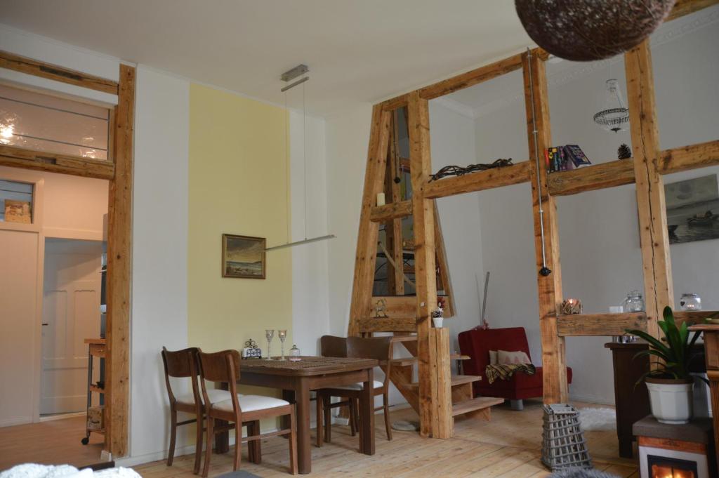 a dining room with a wooden table and chairs at Ferienwohnung Harz Idylle in Güntersberge