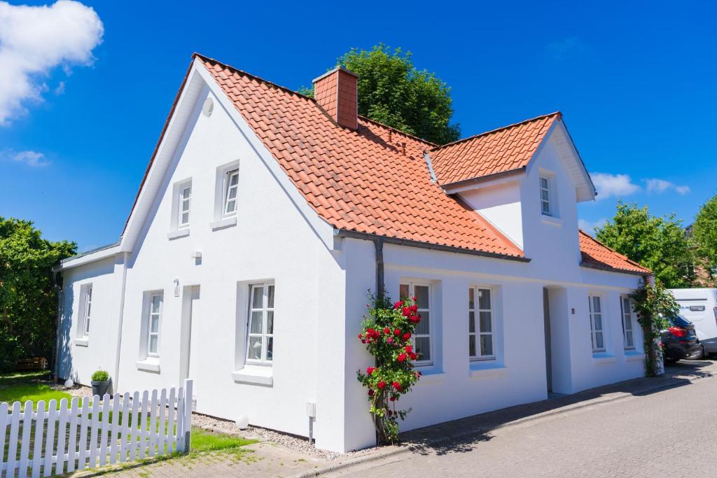 a white house with a red roof at Weitblick in Wesselburen