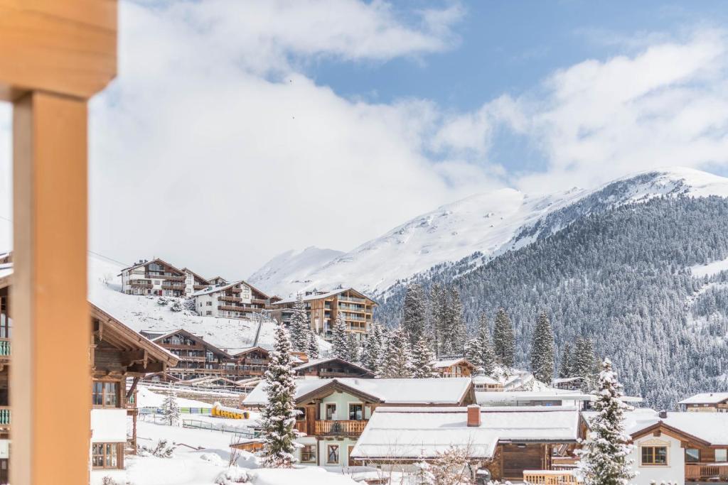 a town covered in snow with mountains in the background at Luisalle Top 1 in Auffach
