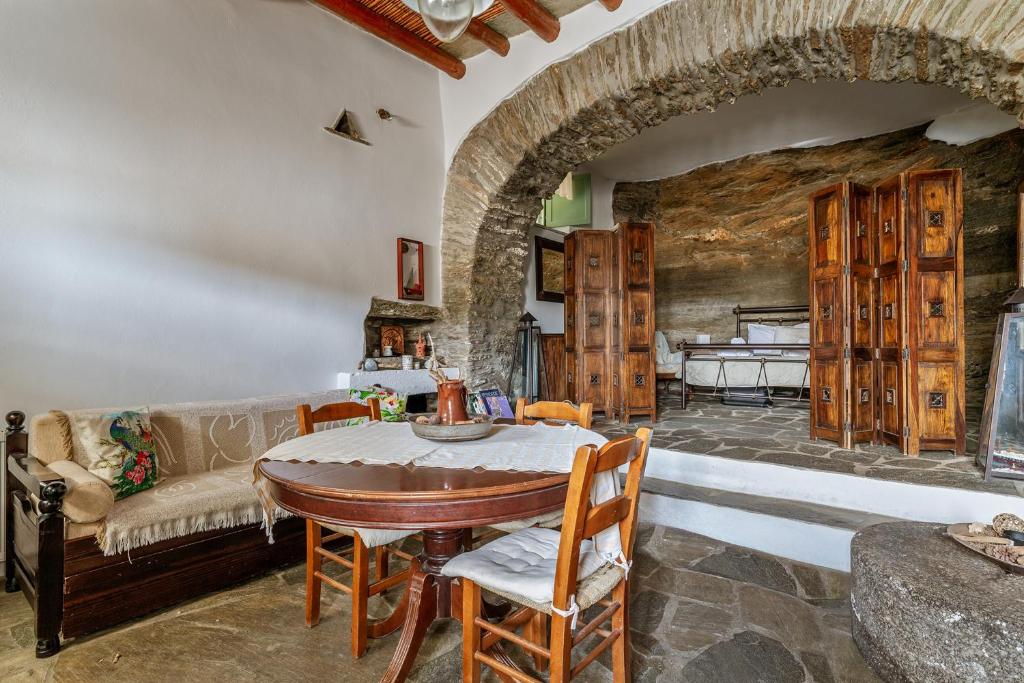 a living room with a table and a couch at Traditional Olive Guesthouse in Fállika