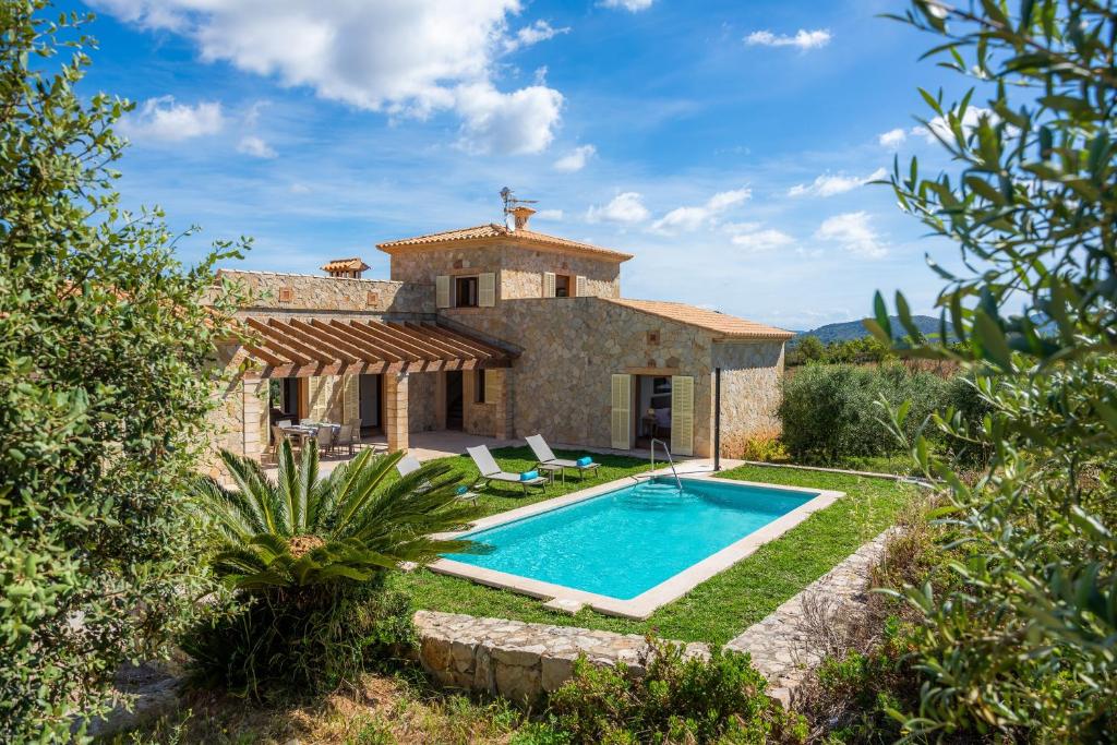 an external view of a villa with a swimming pool at Can Bosco in Son Servera