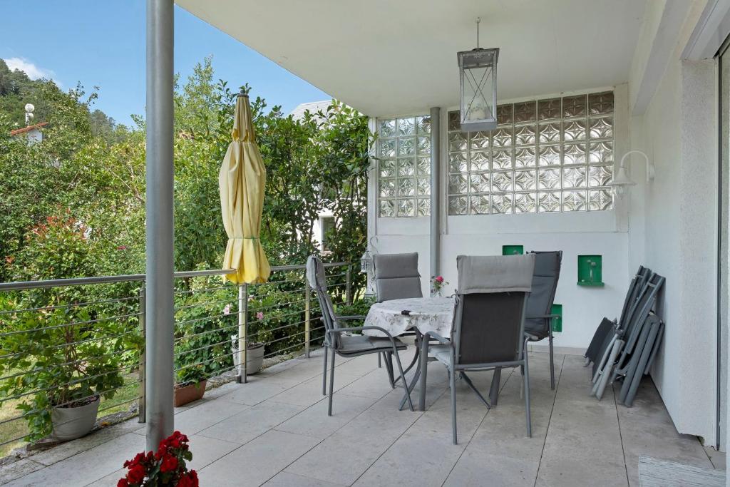 a patio with a table and chairs and an umbrella at Ferienwohnung Paffendorf in Gutach
