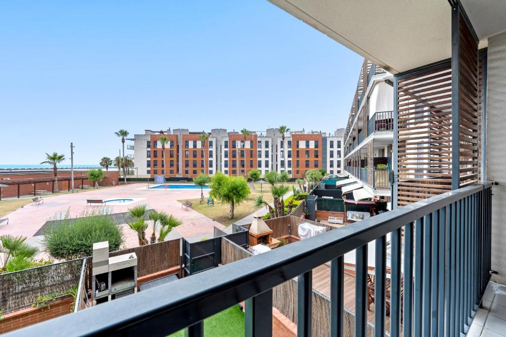 an apartment balcony with a view of a building at Ática Blue Sea in Cubelles