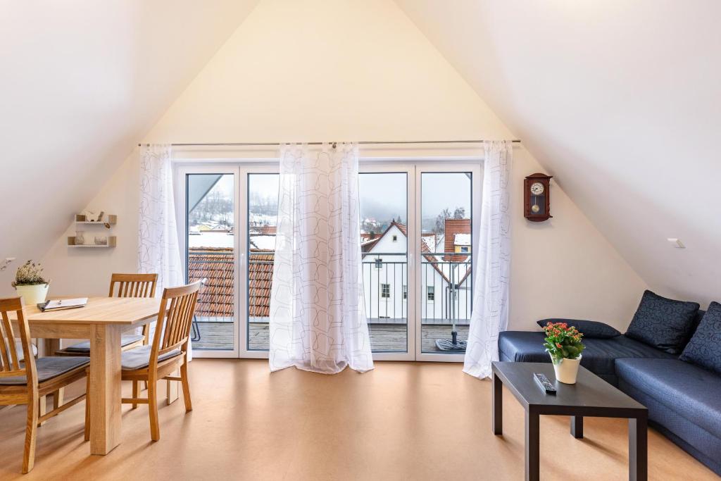 a living room with a blue couch and a table at Hohenzollern in Gammertingen