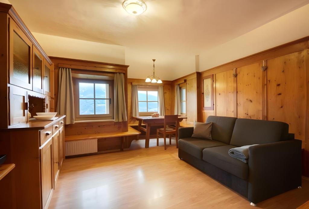 a living room with a couch and a table at Rafaser - Apartment Rustika in Feldthurns