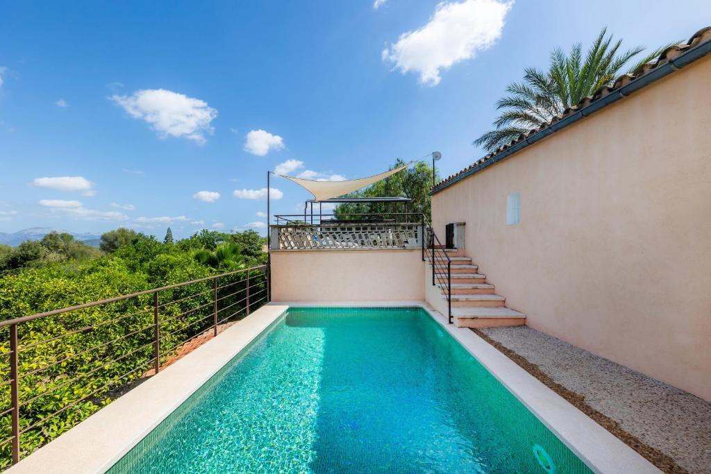 a swimming pool on the balcony of a house at Can Tiro in Islas Baleares