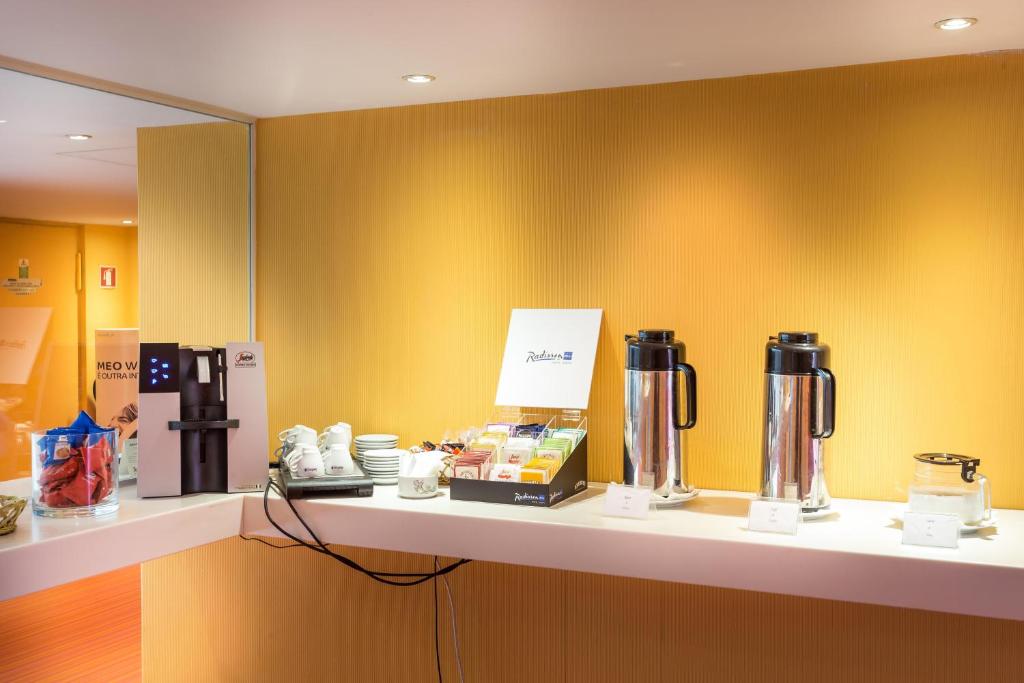 A self-service drinks station with coffee, tea and hot-water flasks.