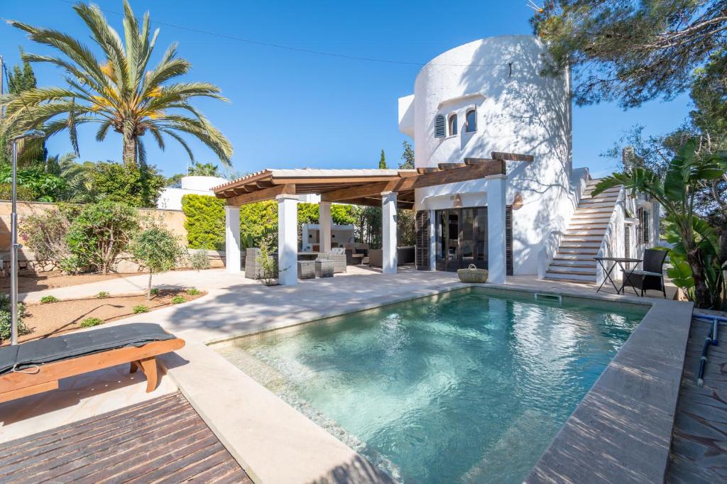 a swimming pool in the backyard of a house at Casa Cala Santanyí in Santanyi