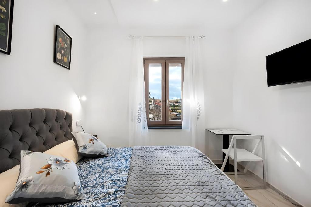 a bedroom with a bed and a window at Silvana's House in Agerola