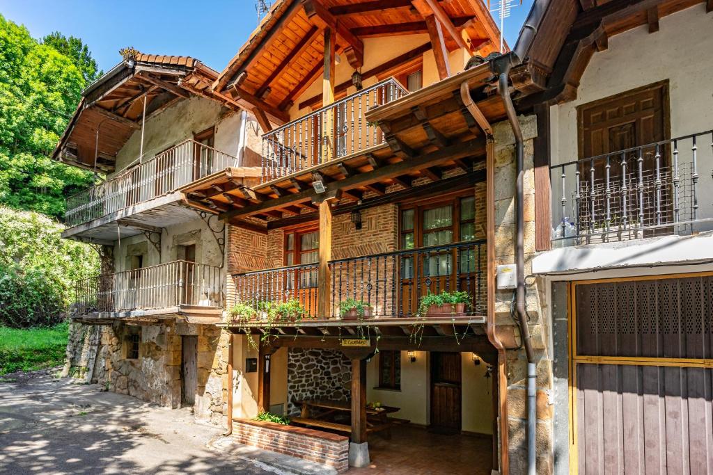 an old building with balconies and plants on it at Casa El Campano in Ontaneda