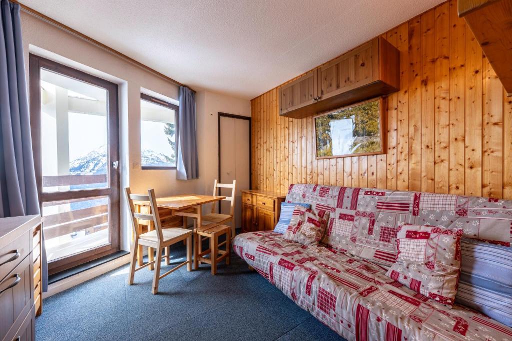 a living room with a couch and a table at Les Bouquetins A in La Rosière