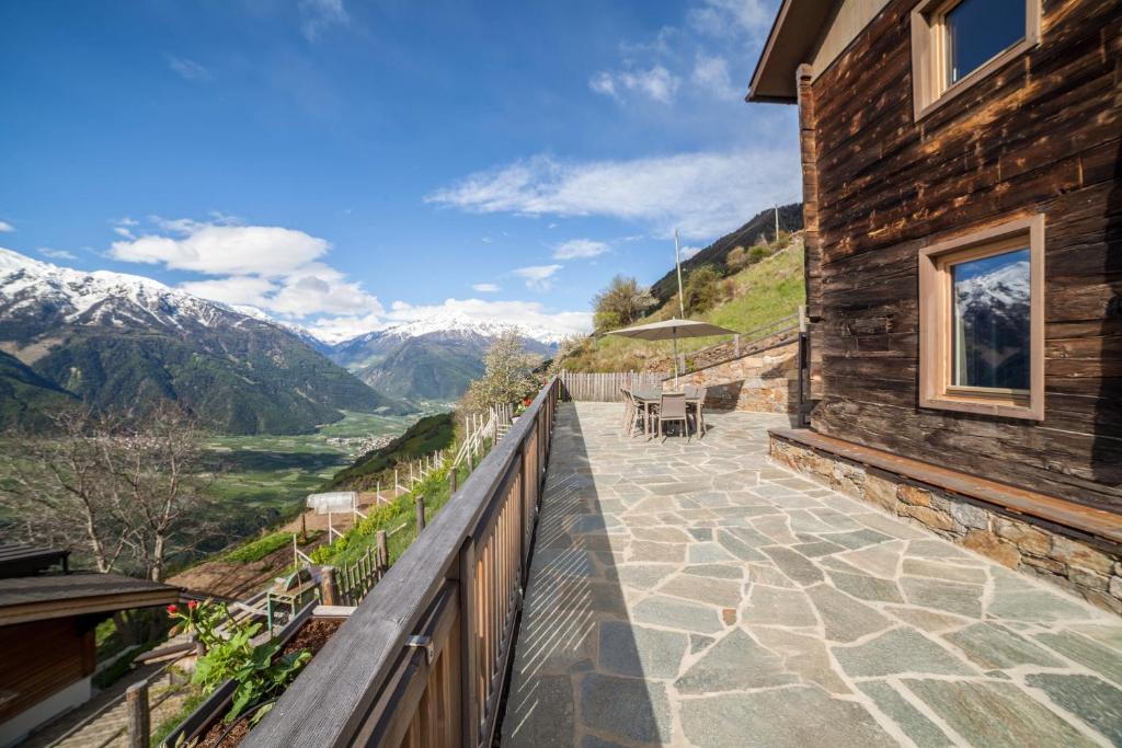 a balcony of a house with a view of the mountains at Flatschhof - Chalet Flatsch in Kastelbell-Tschars