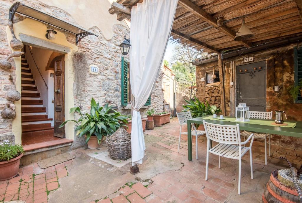 an outdoor patio with a table and chairs at L'arco della Fonte in Gaiole in Chianti