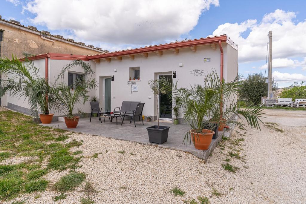 a house with potted plants in front of it at Baglio Netino in Noto