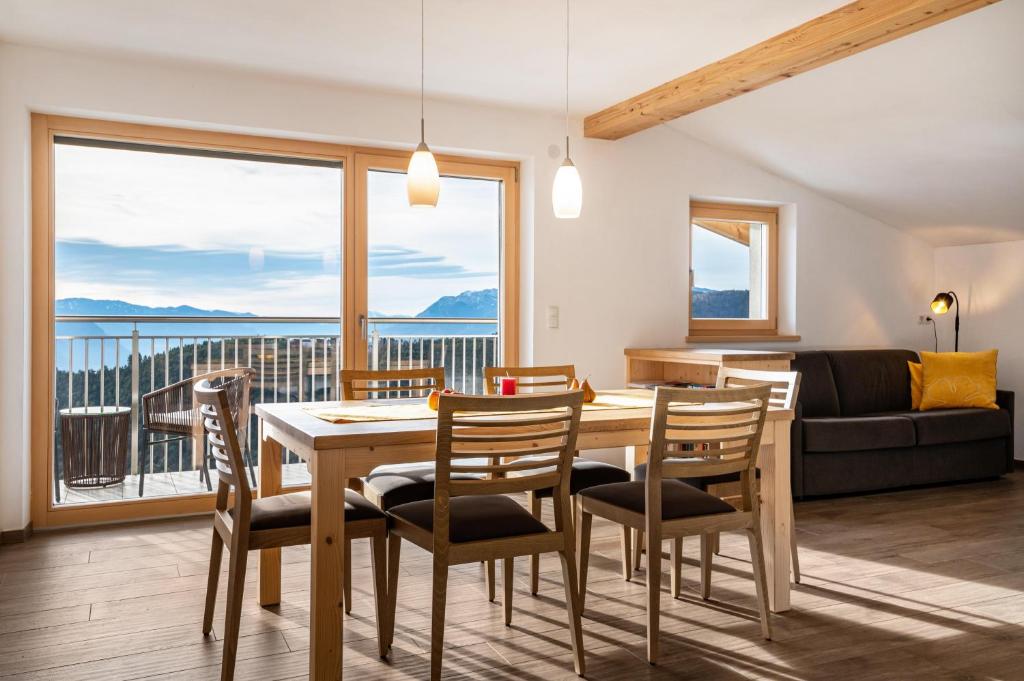a dining room with a table and chairs with a view at Reiterhof Apt Flora in San Genesio Atesino