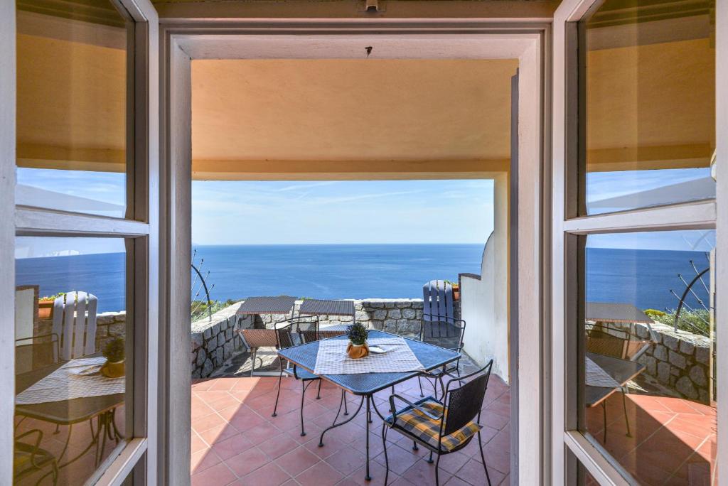 a view of the ocean from the balcony of a house at Mare e natura in Marciana