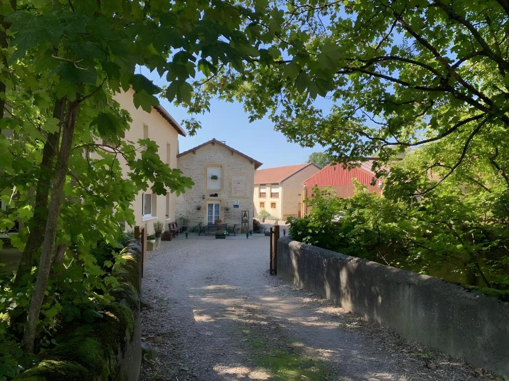 a street in front of a building with trees at A La Cour Basse in Peltre