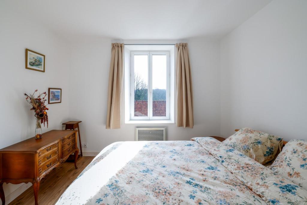 a bedroom with a bed and a window at Chambres d'hôtes pleine nature in Plougonven