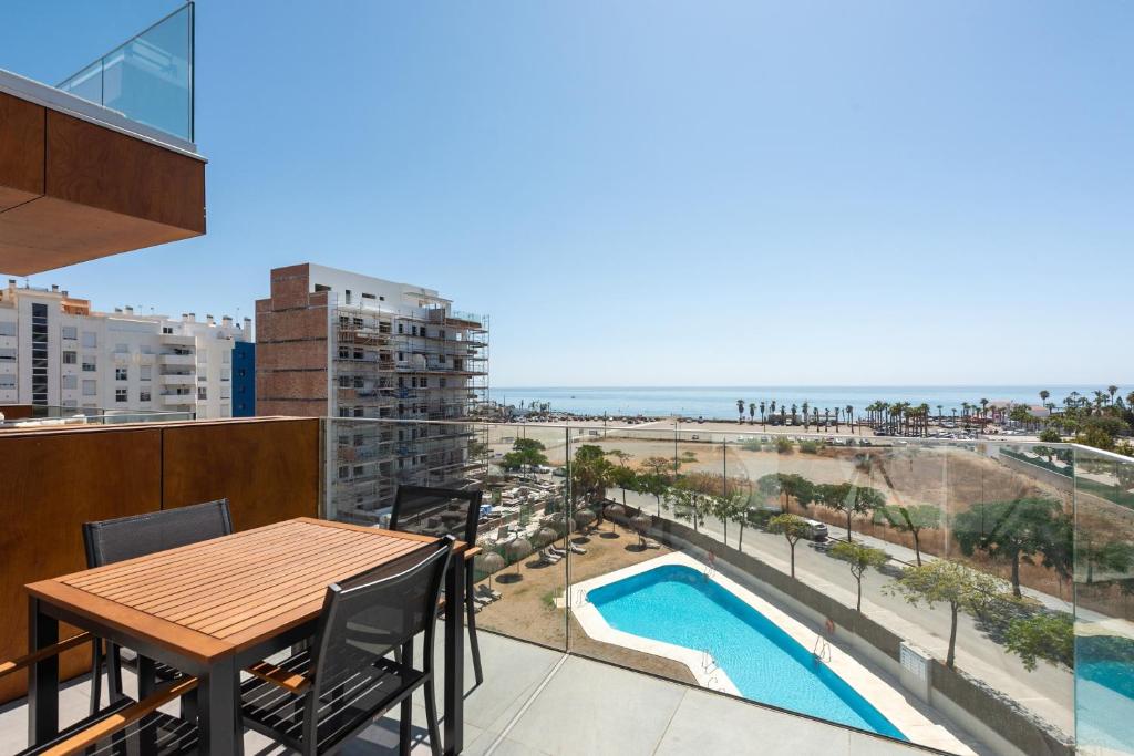 a balcony with a table and a view of the beach at Adhara 053 in Torre del Mar