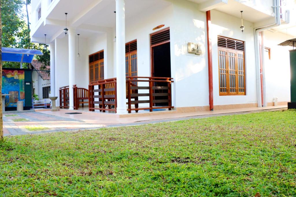 a house with a lawn in front of it at The Cool Nest Yala Hotel in Tissamaharama