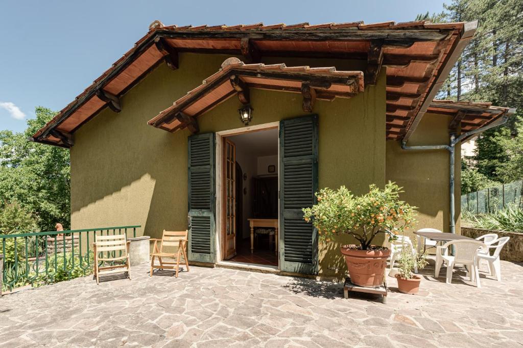 a house with a porch with chairs and a table at Gigli di Firenze in Rufina