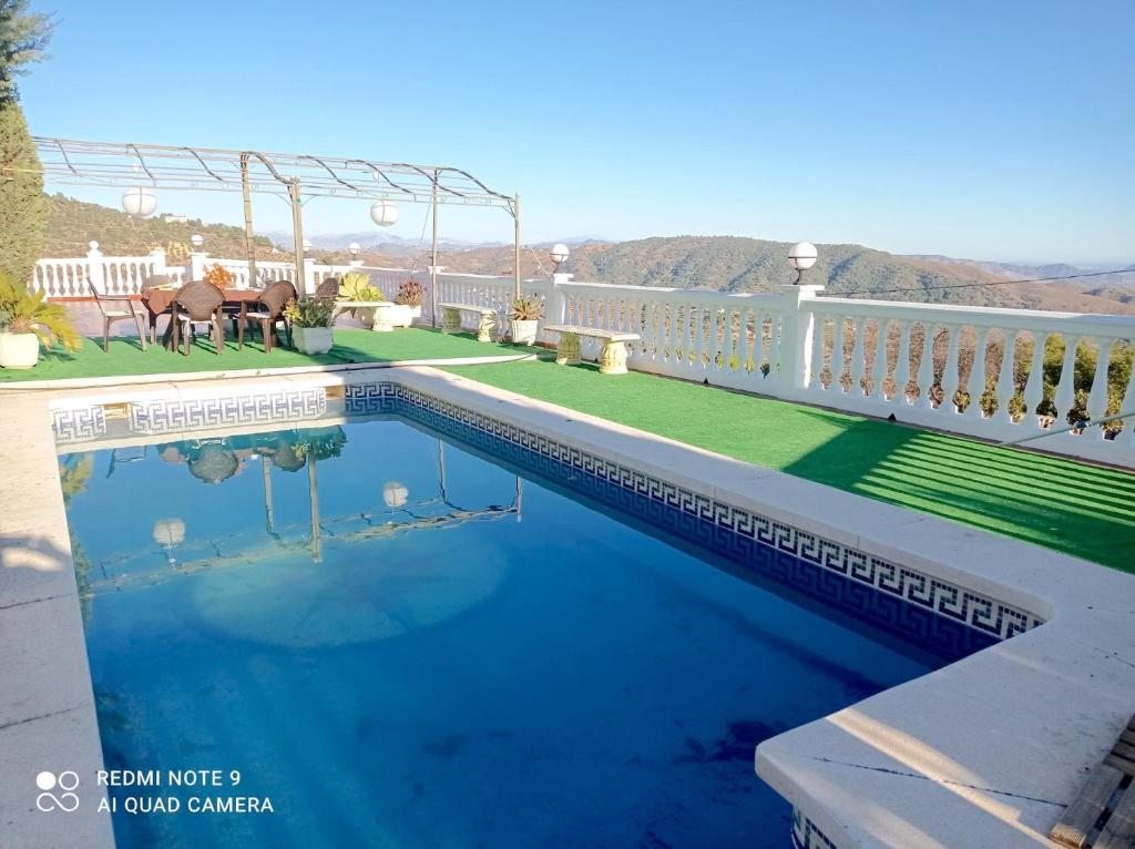 a swimming pool on the balcony of a house at La huerta de Bonela in Casarabonela