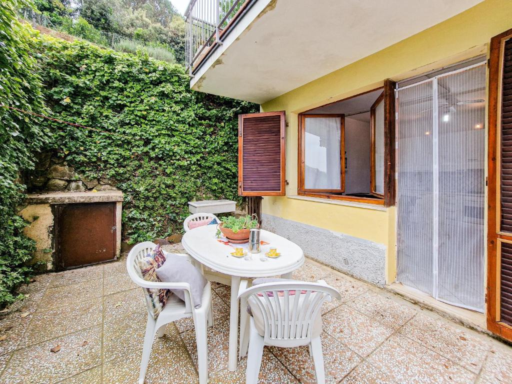 a patio with a white table and two chairs at Bilo Le Lecce 15b in Capoliveri