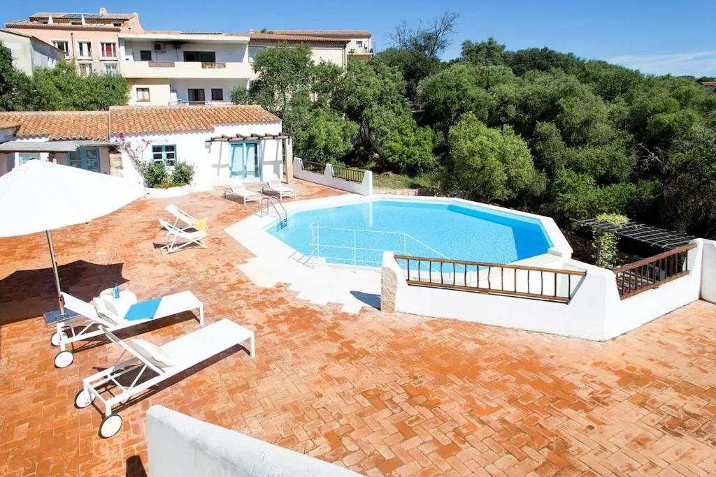an image of a swimming pool in the backyard of a house at Charming house in San Pantaleo in Olbia