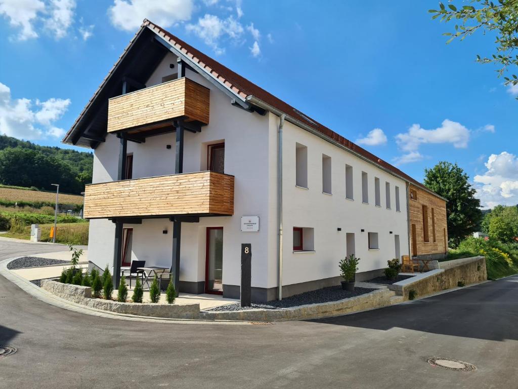 a white building with a black roof at wohnung-nummer-2 in Pielenhofen