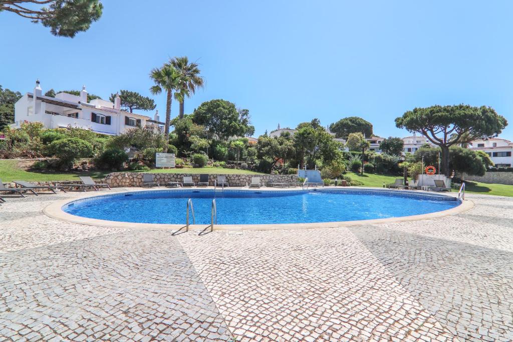 a swimming pool in the middle of a resort at Villa Karon in Almancil