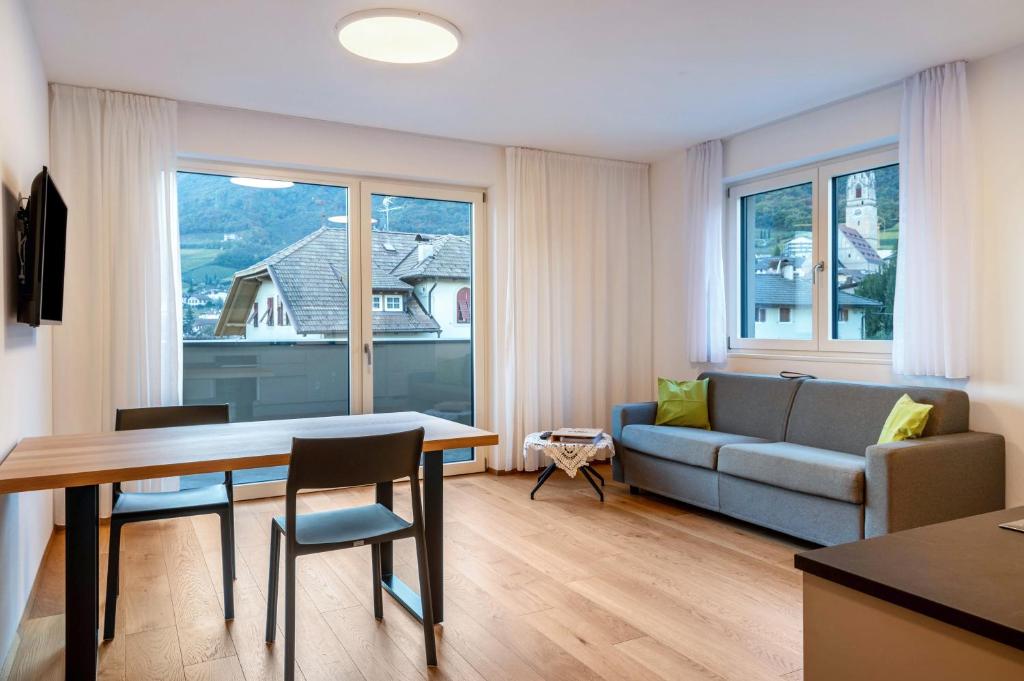 a living room with a couch and a table at Ferienwohnungen Karin - Cabernet in Termeno